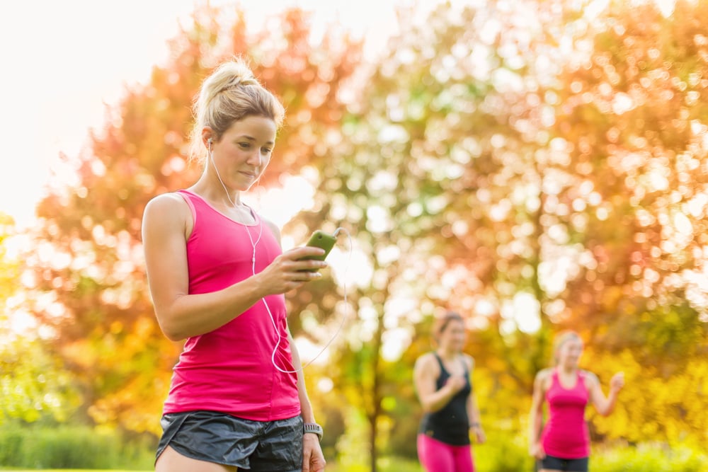 attractive woman listening to music during sport